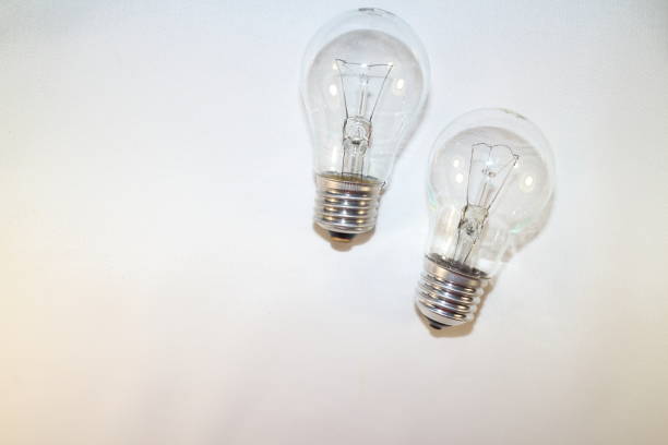 istock two incandescent lamps close-up on a white background 877760472