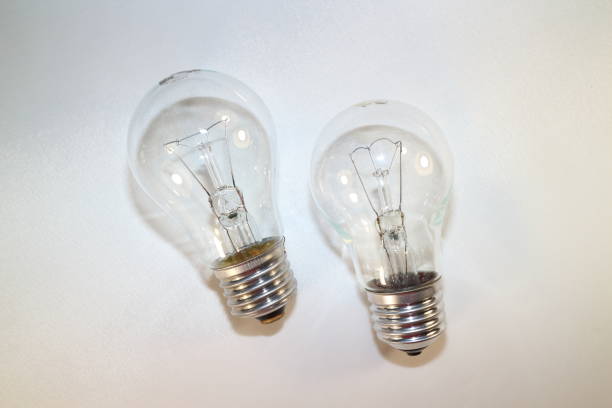 istock two incandescent lamps close-up on a white background 877760616