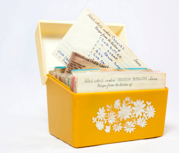 Vintage Recipe Box Old, yellow 1960s recipe box with handwritten recipes on index cards recipe stock pictures, royalty-free photos & images