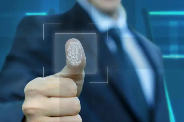 Businessman activates the input fingerprint on blurred background.