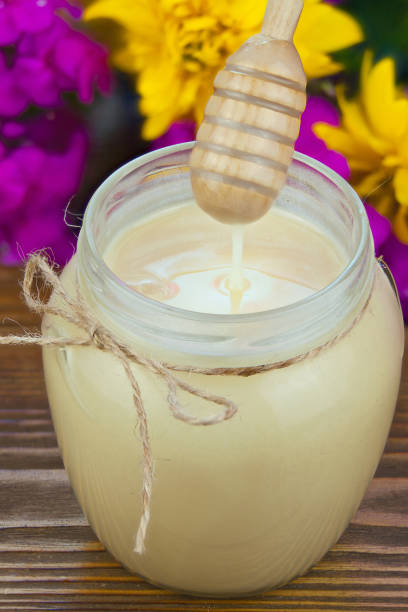 istock Delicious delicious honey in  jar on table 877767768