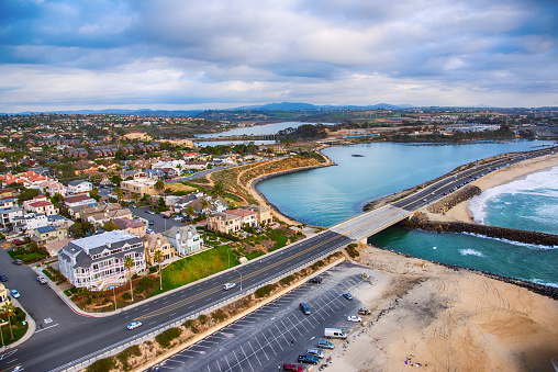 Avila Beach, California, USA - February 2, 2023.  Avila Beach city promenade filled with restaurants, shops, patios, benches, and art.