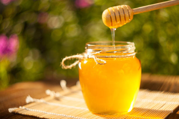 istock Delicious delicious honey in  jar on table 877770918