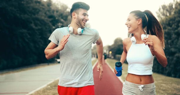 istock Athletic couple jogging in nature 877773758