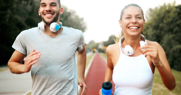 istock Beautiful couple jogging in nature 877773858