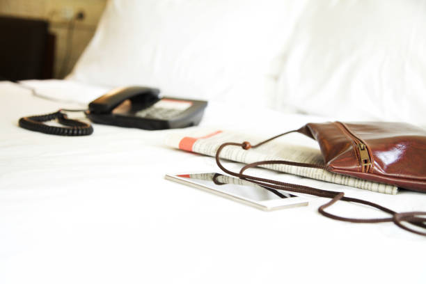 istock Telephone on bed in hotel room 877774094
