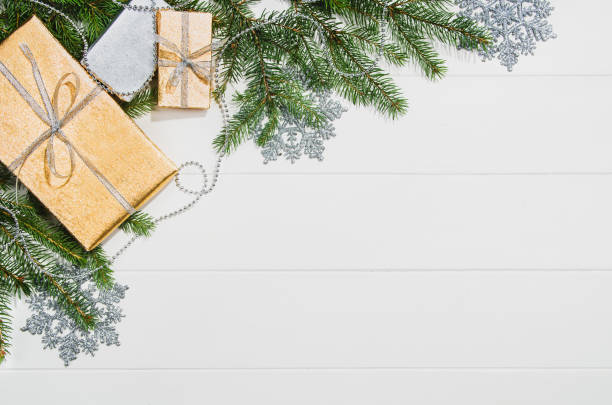 istock Christmas presents or gifts background frame top view on white 877777496