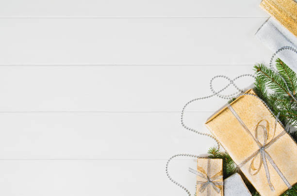 istock Christmas presents or gifts background frame top view on white 877777596
