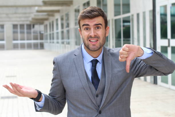 istock Apologetic businessman giving a thumbs down 877778346