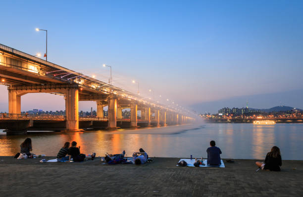 Seoul, South Korea - June 15, 2017: People relaxing and watching fountain show at Han river, landmark of South Korea.