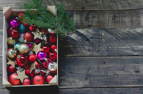 istock christmas balls in rustic box with pine branches on wooden background 877793720