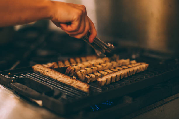 istock Preparing crouton of bread on the grill 877794408