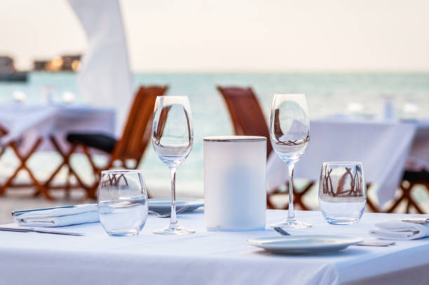 istock Beautiful table set up for a dinner on the beach 877799870