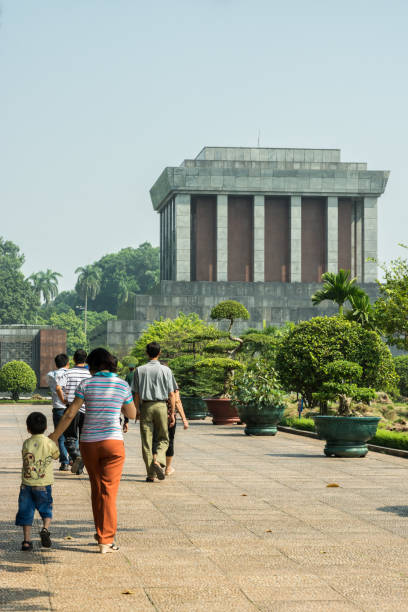 jeune famille à marcher vers le mausolée de ho chi minh à hanoi, vietnam - vietnam travel destinations ho chi minh city ho chi minh photos et images de collection