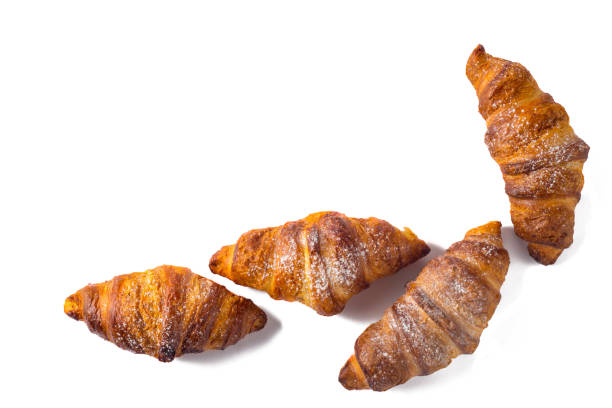 istock Four croissant sprinkled with powdered sugar isolated on a white background 877810716