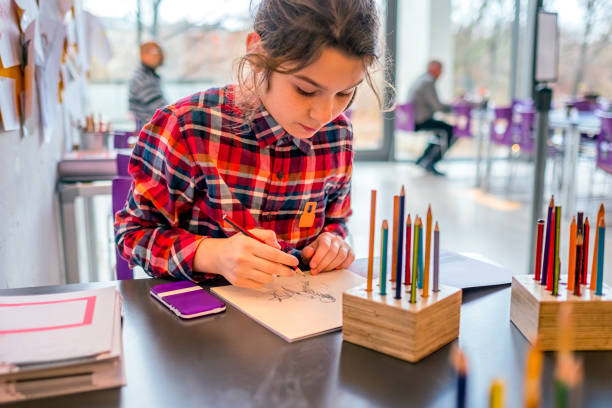 Cute schoolgirl drawing with pencils. Cute schoolgirl drawing with pencils. A concept of teaching drawing, master classes in museums. Children's creativity, education. Danish national gallery. Educational programs. pencil drawing photos stock pictures, royalty-free photos & images