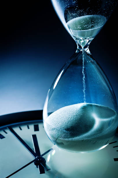 istock Deadline and Out of Time: Sand Timer Hourglass and Clock at Midnight 877811492