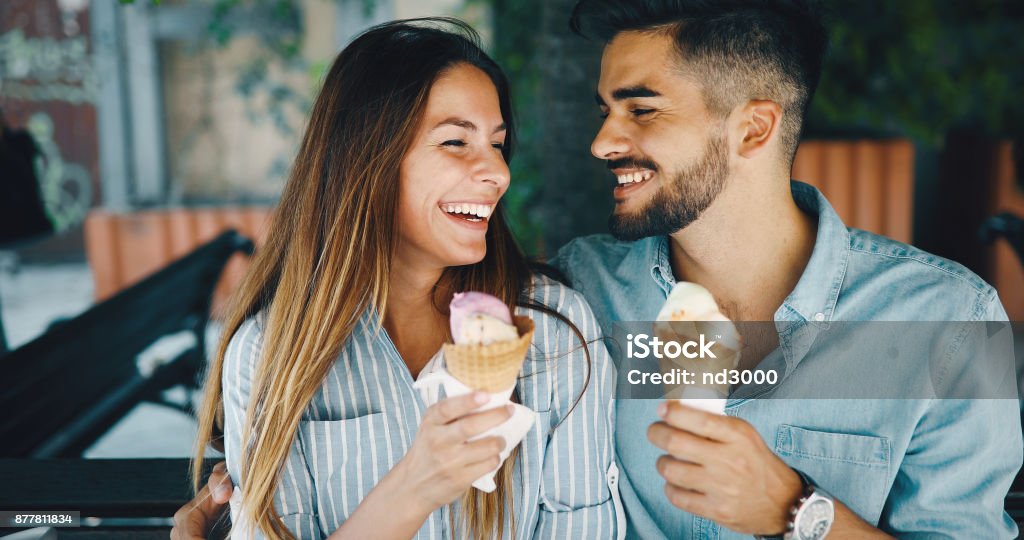 Happy couple having date and eating ice cream Happy young couple having date and eating ice cream Ice Cream Stock Photo