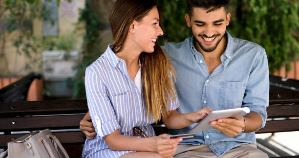 istock Couple in love shopping online using tablet 877821166