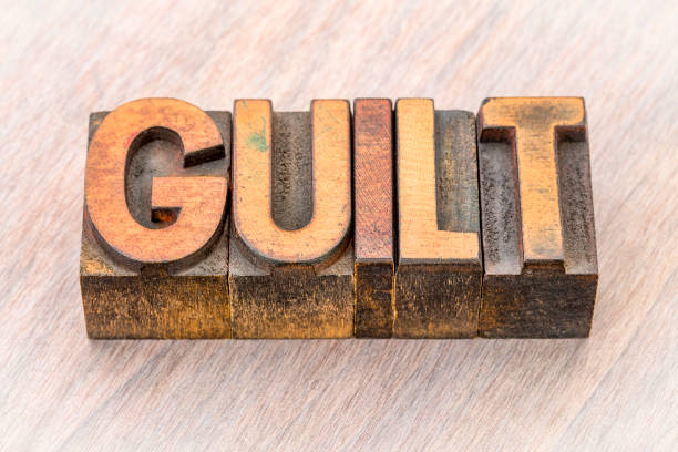 istock guilt word abstract in wood type 877822376