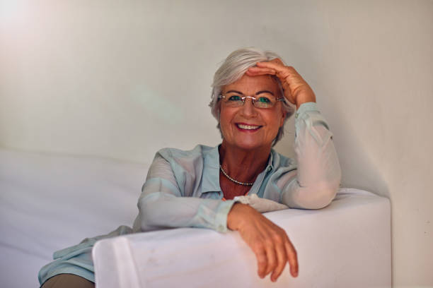 Shoot of pretty senior woman sitting at home and thinking about something