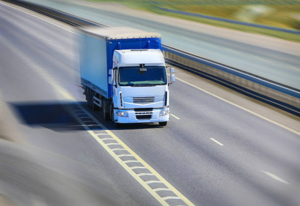 istock truck moves on highway 877825606