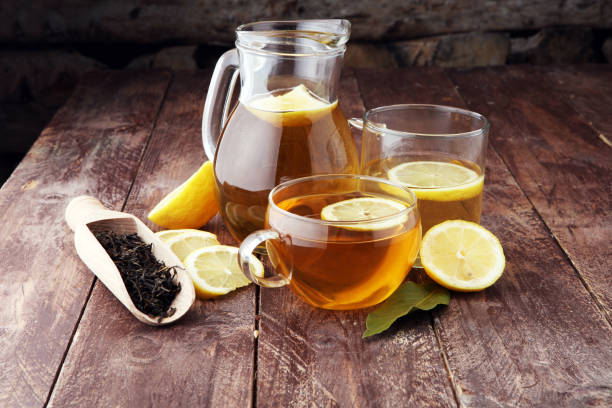 istock Hot tea in a transparent cup. Tea with lemon fruits. Warming drink. 877826390