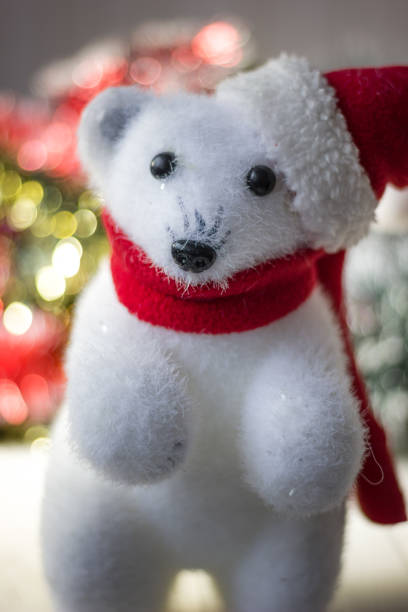 istock White bear toy as christmas decoration, with santa hat. 877832640