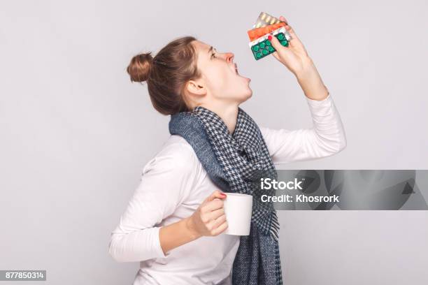 Sick Young Woman Holding Cup With Tea Many Pills Antibiotics Stock Photo - Download Image Now