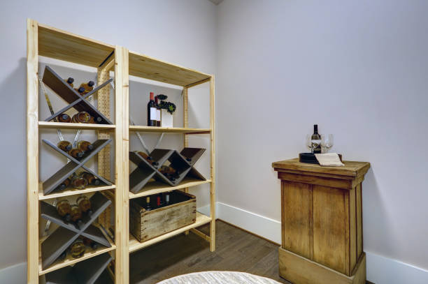 istock Wine room with wooden wine racks and wine tasting table. 877864670