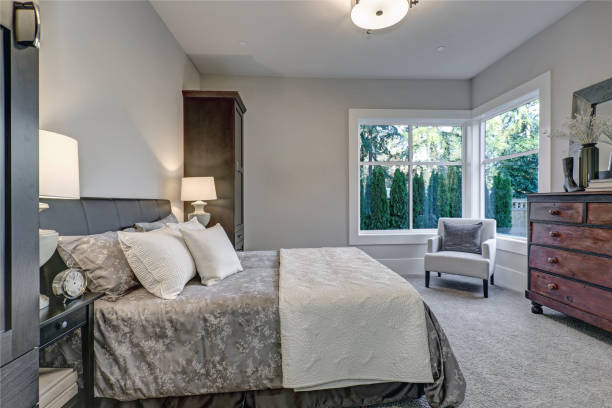 istock Cozy bedroom interior features soft gray walls 877873166