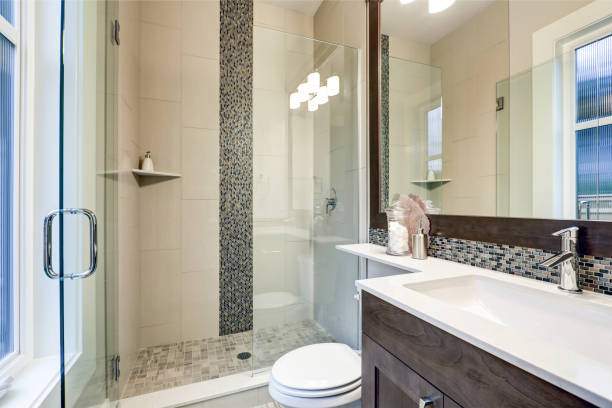 istock Bright new bathroom interior with glass walk in shower 877874158