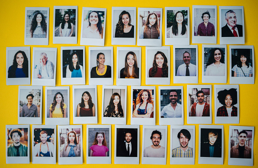 Polaroid photos of different people hanged on the wall.