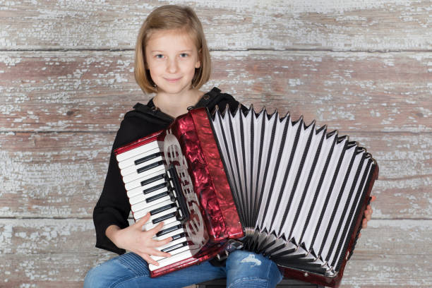 istock Young girl with an accordion 877876816