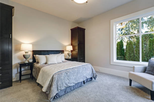 istock Cozy bedroom interior features soft creamy walls 877876888