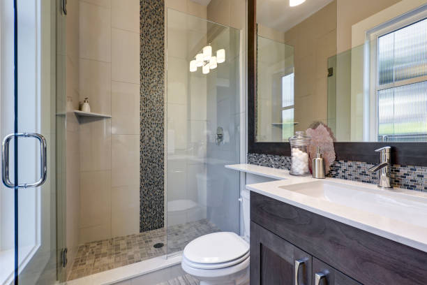 istock Bright new bathroom interior with glass walk in shower 877877970