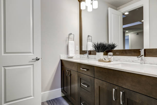 istock White and brown bathroom boasts a nook filled with double vanity 877878084