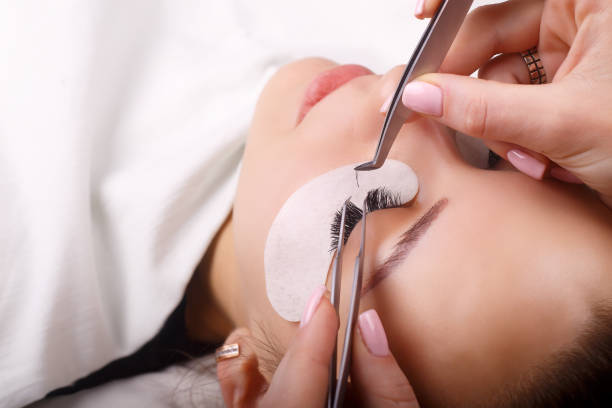 Eyelash Extension Procedure. Woman Eye with Long Eyelashes. Lashes, close up, macro, selective focus