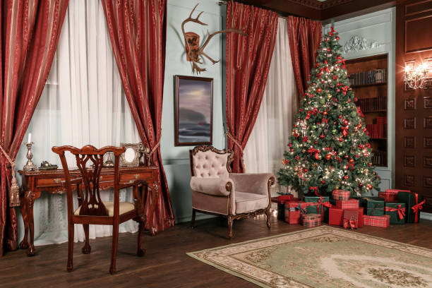 istock Christmas evening. classic apartments with a white fireplace, decorated tree, sofa, large windows and chandelier. 877899010