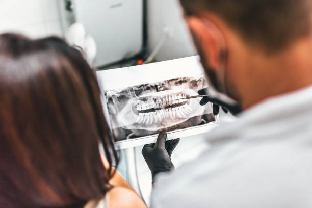 istock Dentist with patient in dental clinic 877899136