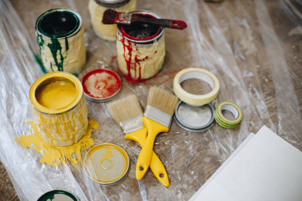 Jars of paint, brushes and duct tape