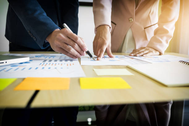 istock Midsection Of Business People Working At Office 877948924