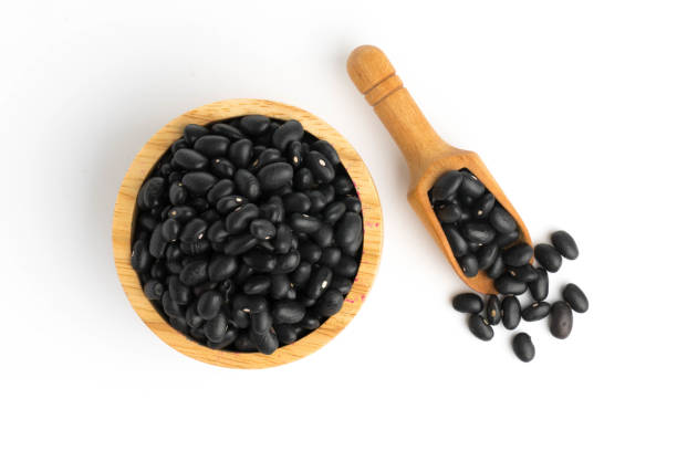 istock Black bean on cup isolated  top view on a white background 877959516
