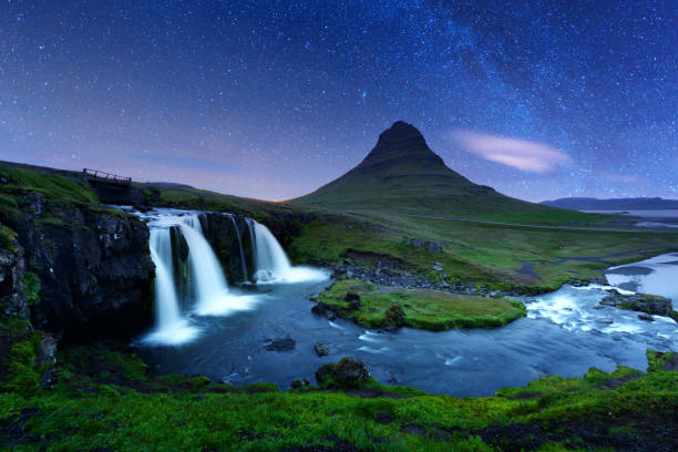istock Starry sky on Kirkjufellsfoss waterfall. 877984694