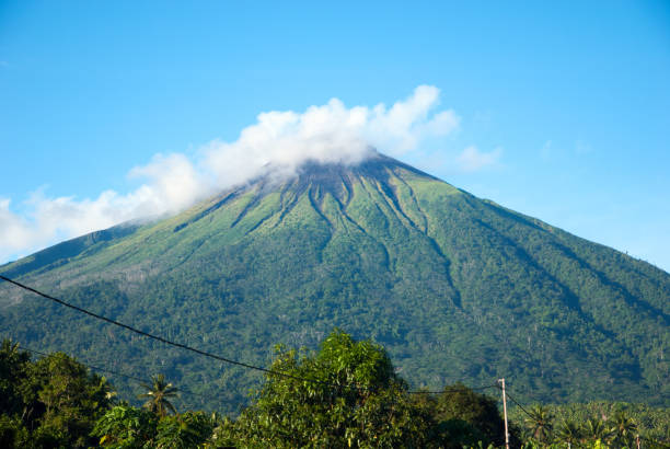 Mount Gamalama Gamalama as seen from a village in Ternate. Gamalama is a near-conical stratovolcano that comprises the entire Ternate island in Indonesia ternate stock pictures, royalty-free photos & images