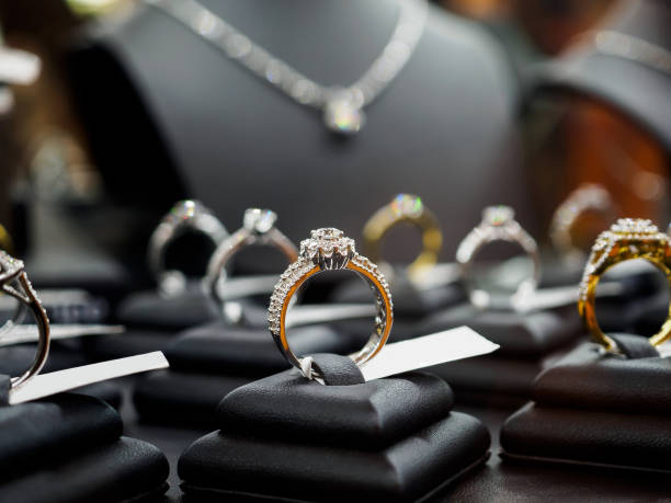 Jewelry diamond rings and necklaces show in luxury retail store window display Jewelry diamond rings and necklaces show in luxury retail store window display showcase diamond ring stock pictures, royalty-free photos & images