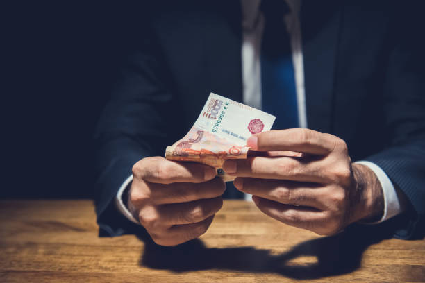 istock Corrupted business man with Russian Ruble bank notes 877998166