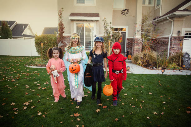 istock Group of Kids Trick or Treating on Halloween 878008376