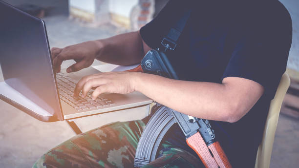 istock Midsection Of Army Soldier Using Laptop 878011864