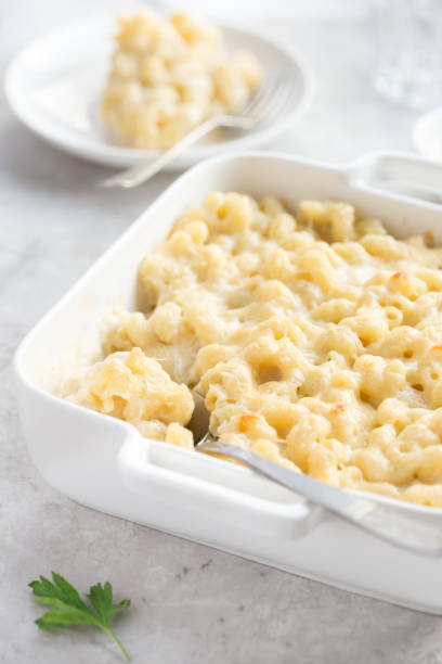 istock mac & cheese, baked macaroni and cheese in white casserole dish 878012296